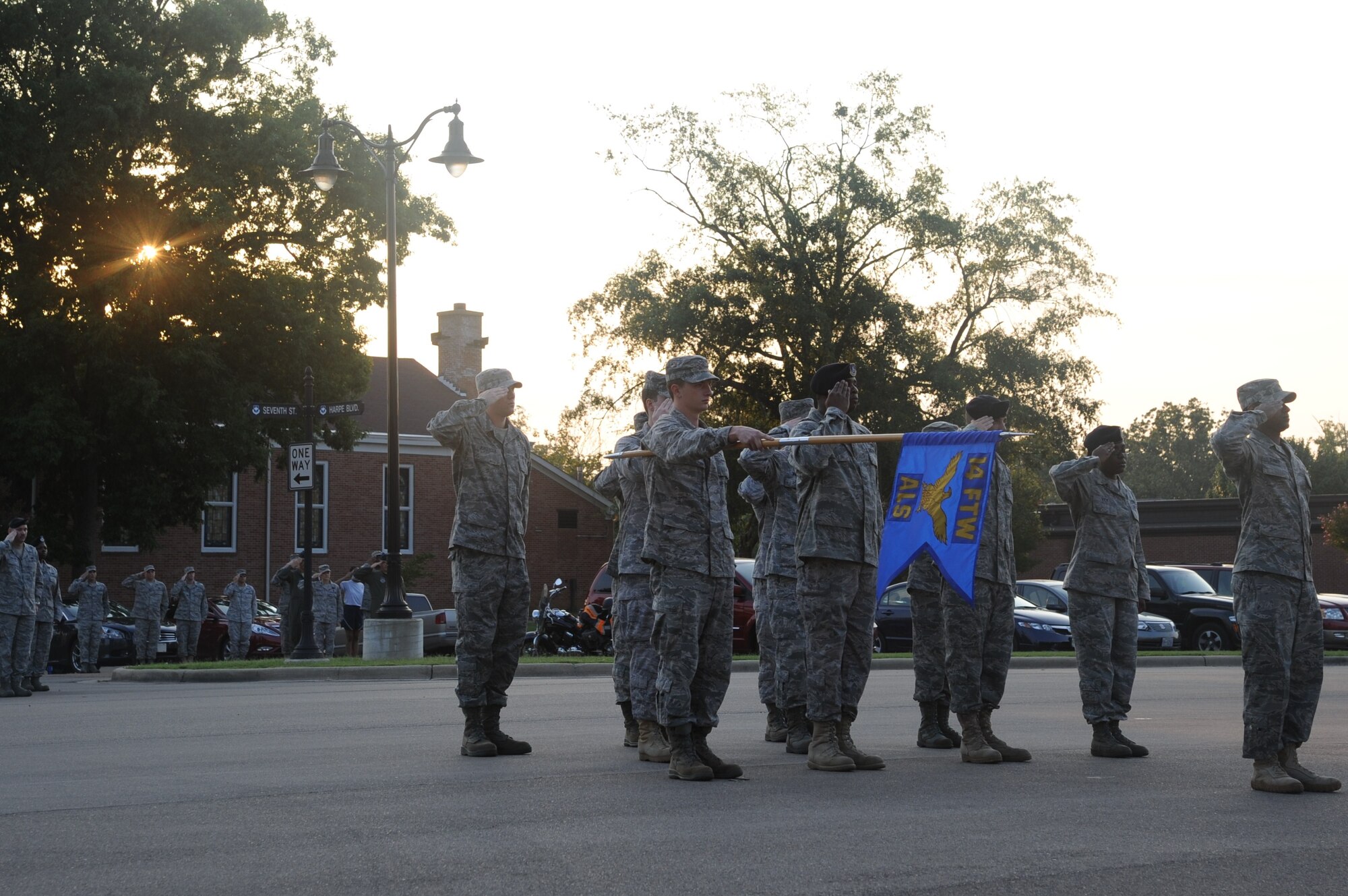 The Airmen Leadership Class 11-07 at Columbus Air Force Base salute during reveille on Aug. 23 at Smith Plaza as members of Team BLAZE join them. The sounding of reveille typically calls the beginning of the duty day. (U.S. Air Force photo/Airman 1st Class Chase Hedrick)