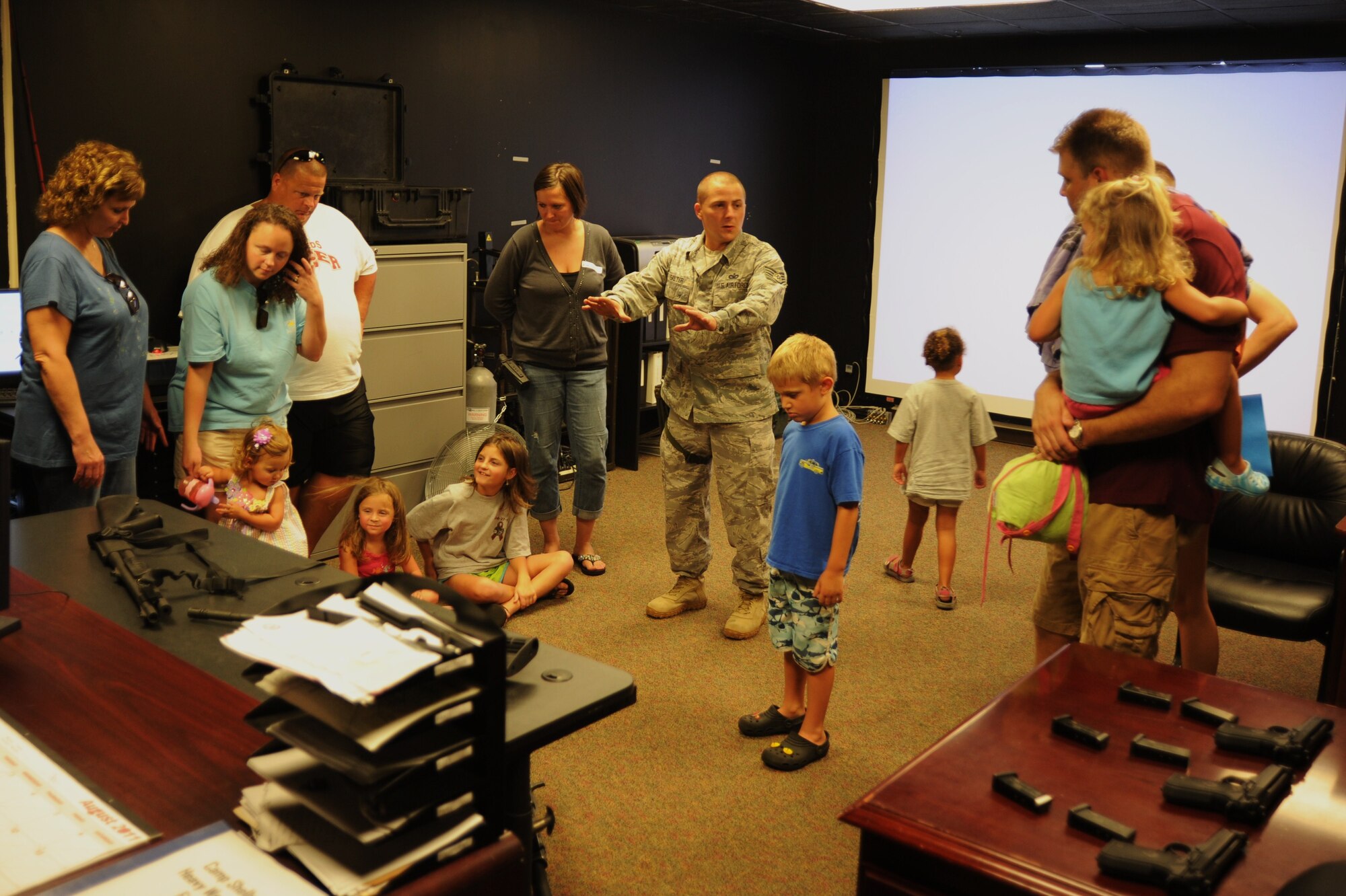 Tech. Sgt. Damon Salter, 14th Security Force Squadron member, educates friends and family of the 14th SFS about the Fire Arms Training System during a unit event to promote camaraderie, understanding and thanks to defenders' loved ones Saturday, Aug. 21 here. (U.S. Air Force photo/Staff Sgt. Bryan Franks)