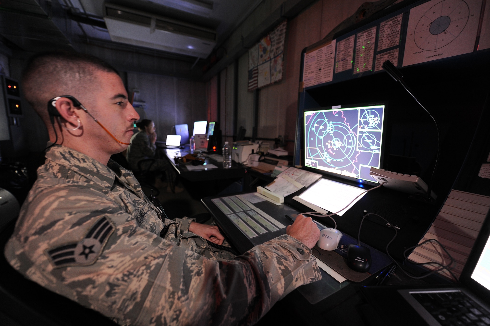 Air Force Senior Airman David O'Connell and Staff Sgt. Andrea Scheving, Radar Approach Control, help planes get to their destinations quickly and safely at Kirkuk Air Base. Airman O'Connell helps provide weather, safe altitudes, and traffic patterns for flights  and destinations. (U.S. Air Force photo by Senior Airman Tristin English)