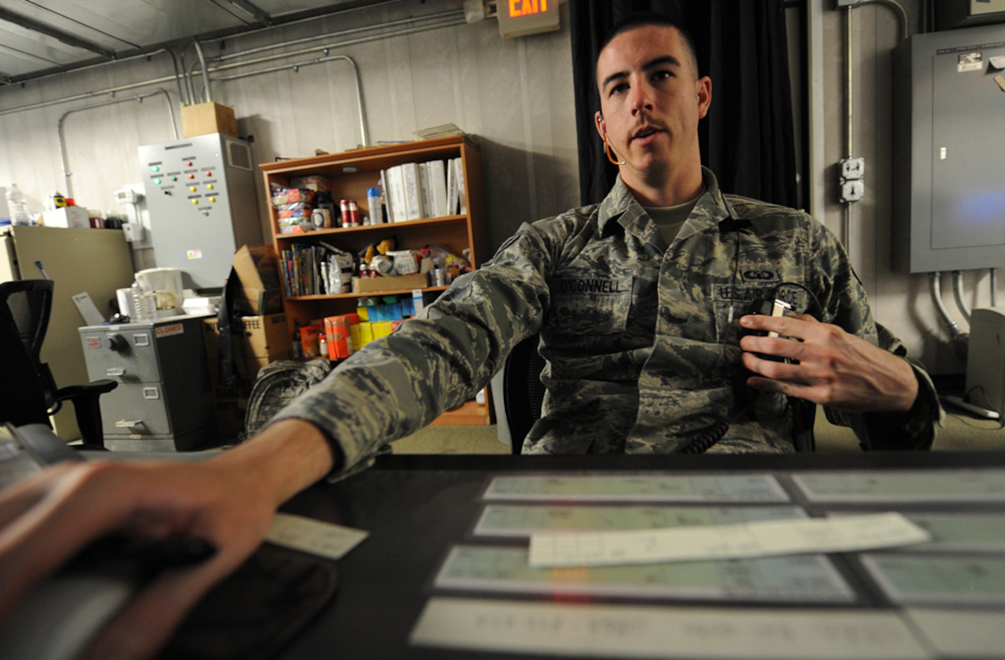 Air Force Senior Airman David O'Connell, Radar Approach Control, talks to pilots over the radio letting the pilot know what he can and can't do at Kirkuk Air Base. Airman O'Connell's goal is to get every aircraft safely to their destination and as quickly as possible. (U.S. Air Force photo by Senior Airman Tristin English)