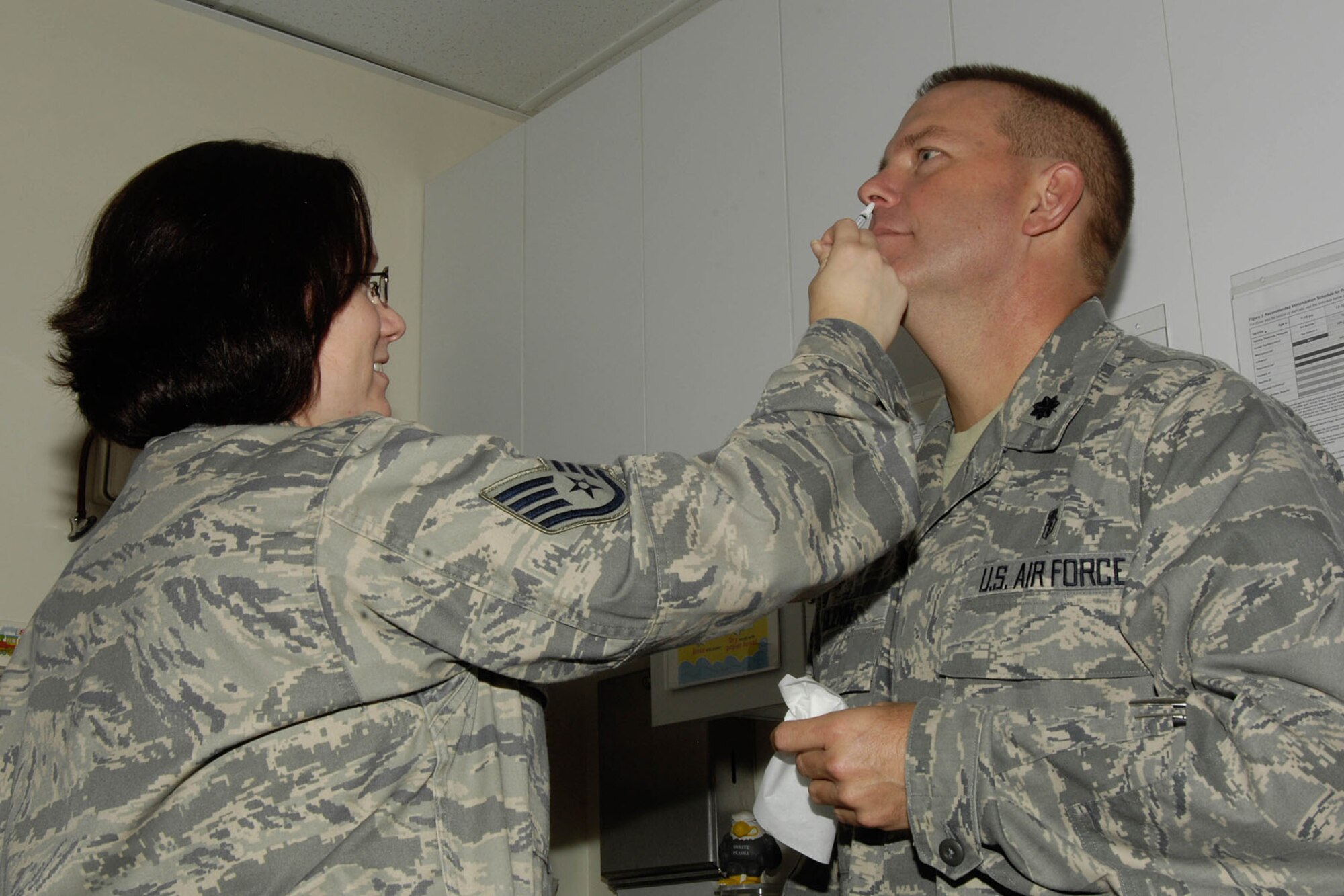 HANSCOM AIR FORCE BASE, Mass. – Staff Sgt. Lori McCarty, NCO in charge of the immunizations clinic, administers the flu vaccine to Lt. Col. Frank Glenn, 66th Medical Squadron commander, in the clinic Aug. 19. At this time, only active duty members are eligible to receive the vaccine, but the medical squadron will issue notices about eligibility as more vaccines become available. (U.S. Air Force photo by Linda LaBonte Britt)