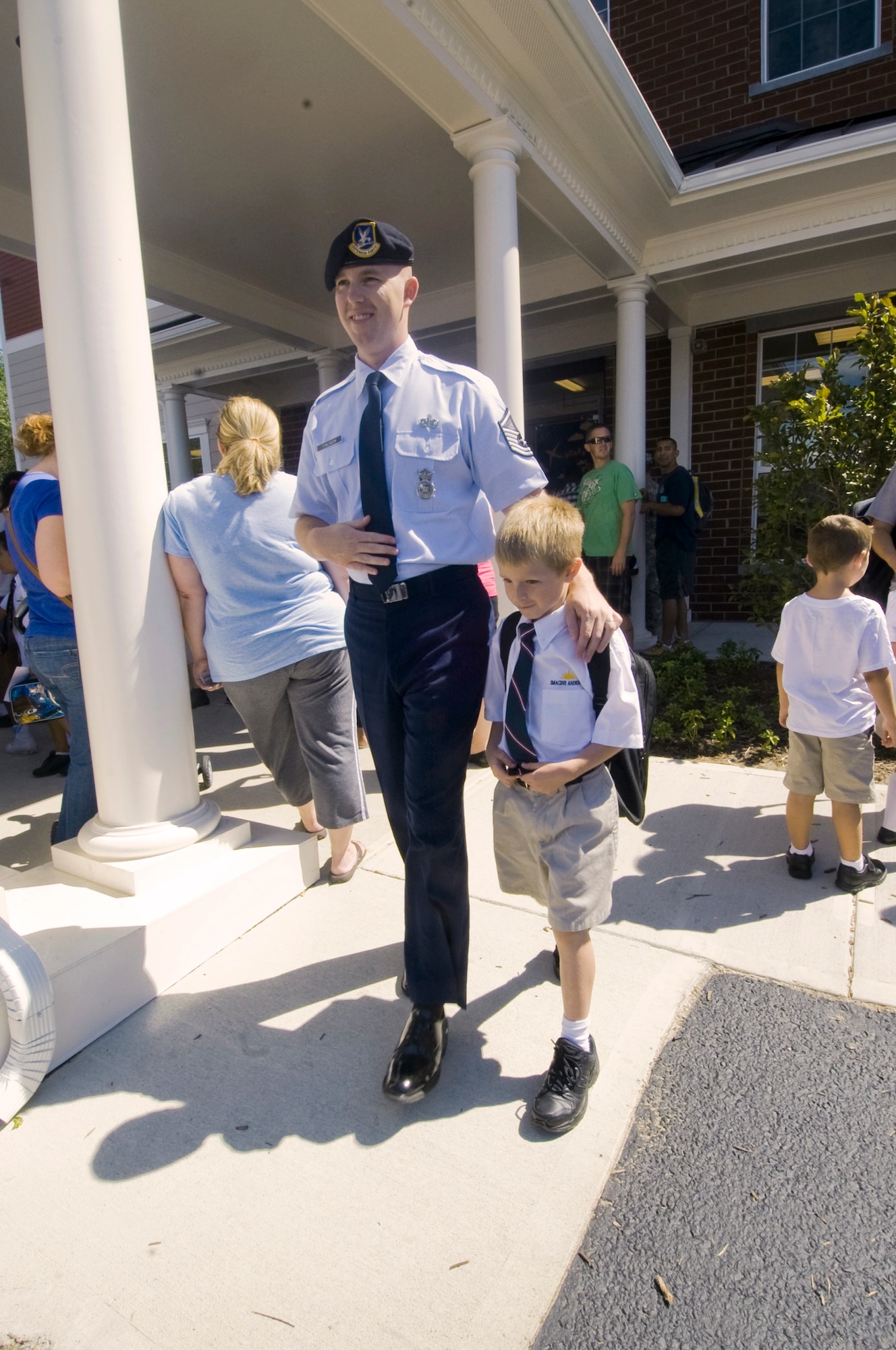 Master Sgt. Todd Tomlinson, 11th Security Forces Squadron flight sergeant, departs Imagine Andrews Public Charter School at the conclusion of his 7-year-old son Tyler’s first day of school here Aug. 22. Imagine Andrews, supports kindergarten through fourth grade elementary school with approximately 265 students. A grade will be added each year, with the expectation of being a kindergarten-through-8th grade school serving about 500 students. (Photo by Bobby Jones)  
 
