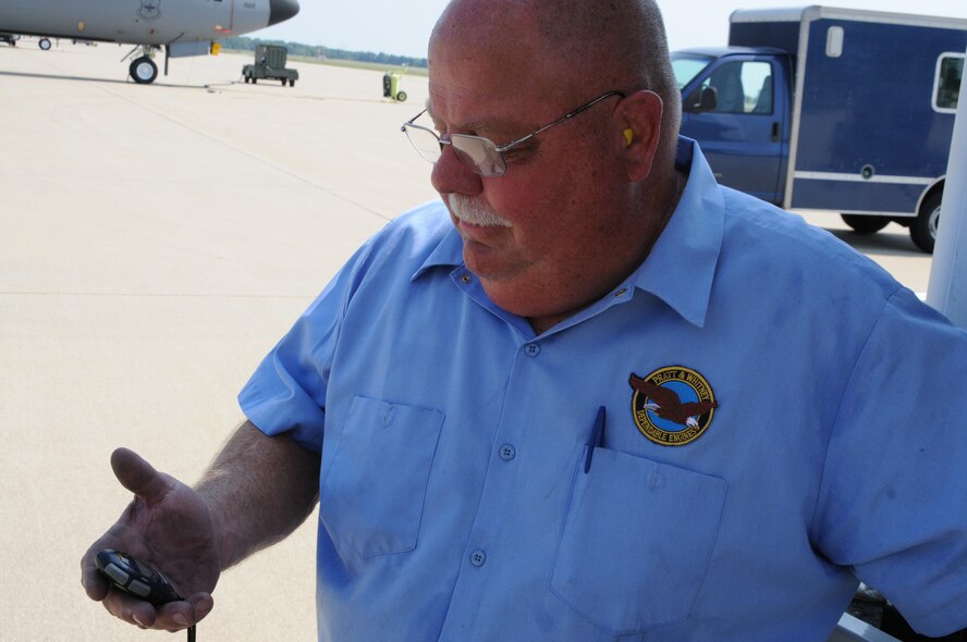 Mike Ashmore, an Eco Wash Team member from Pratt & Whitney, Dallas, Tex., monitors the spray time of the ECO System engine washer during the cleaning of a CFM International CFM56 engine (F108 military designation) on a KC-135R Stratotanker at Scott AFB, Ill., on August 24, 2011. To avoid over heating the engine it is sprayed for two minutes followed by a five minute cool down period. This is repeated three times for each of the four engines on a Stratotanker. The 126th Air Refueling Wing, Illinois Air National Guard, is participating in the engine wash as a fuel conservation measure. Washing the engine is expected to reduce the Exhaust Gas Temperature (EGT) margin by 5-6 degrees resulting in fuel savings and longer engine life. (U.S. AF photo by Master Sgt. Ken Stephens) (Released)