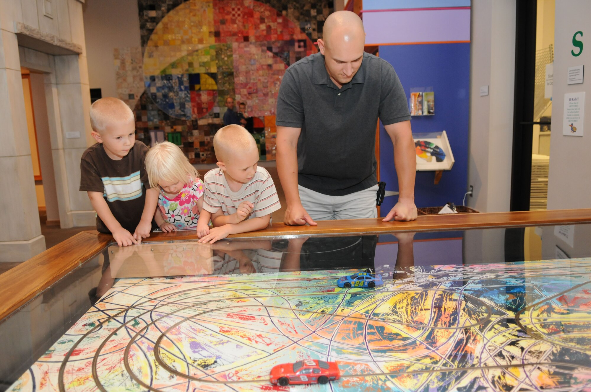 ACSC student Maj. David Simms, with sons Brad and Alex and daughter Kate take part in the ‘Race to Abstraction’ display in the Artworks area. The area was filled with activities and special exhibits designed to interest youth. (Air Force photo/Chris Baldwin)