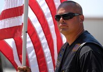 TSgt Jeff Simmons, 138th Fighter Wing, stands with Patriot Guard riders as well as other Oklahoma Army and Air National Guardsmen awaiting the opportunity to pay their respects, as the procession of Army Specialist Joshua M. Seals departs the Oklahoma Air National Guard base in Tulsa, OK.  Specialist Seals was a member of the 45th Infantry Brigade, Oklahoma National Guard, serving on Operation Enduring Freedom in Afghanistan.  (U.S. Air Force photo by Master Sergeant Preston L. Chasteen)