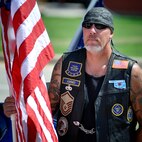 MSgt Michael Lollman, 138th Fighter Wing, stands with Patriot Guard riders as well as other Oklahoma Army and Air National Guardsmen awaiting the opportunity to pay their respects, as the procession of Army Specialist Joshua M. Seals departs the Oklahoma Air National Guard base in Tulsa, OK.  Specialist Seals was a member of the 45th Infantry Brigade, Oklahoma National Guard, serving on Operation Enduring Freedom in Afghanistan.  (U.S. Air Force photo by Master Sergeant Preston L. Chasteen)
