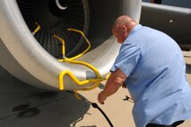Mike Ashmore, an Eco Wash Team member from Pratt & Whitney, Dallas, Tex., installs the wash hose of an ECO System to the front of a CFM International CFM56 engine (F108 military designation) on a KC-135R Stratotanker at Scott AFB, Ill., on August 24, 2011. The hose sprays water through the engine and washes off deposits and build ups. The 126th Air Refueling Wing, Illinois Air National Guard, is participating in the engine wash as a fuel conservation measure. Washing the engine is expected to reduce the Exhaust Gas Temperature (EGT) margin by 5-6 degrees resulting in fuel savings and longer engine life. (U.S. AF photo by Master Sgt. Ken Stephens) (Released)