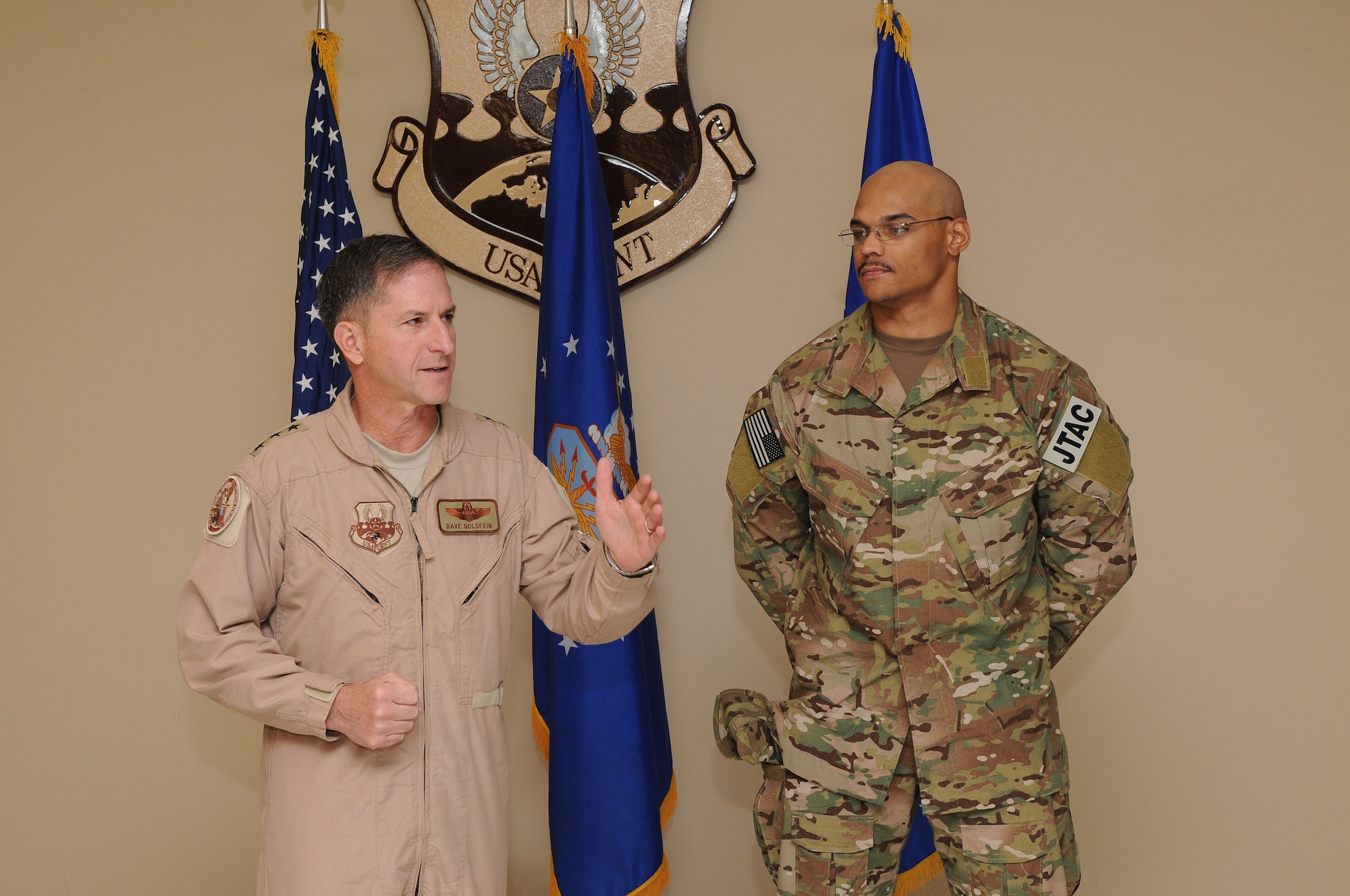 Lieutenant General David Goldfein, commander of U.S. Air Forces Central Command, introduces Senior Airman Jorge Henry, a joint terminal attack controller deployed to the 817th Expeditionary Air Support Operations Squadron, before presenting him with a Purple Heart for wounds sustained in a nine-hour battle in Afghanistan August 12, 2011. Henry, deployed from the 25th Air Support Operations Squadron, Schoefield Barracks, Hawaii, sustained a gunshot wound to the hand early in the battle and continued to call in close air support throughout the firefight. He received a Purple Heart and an Air Force Combat Action Medal, August 25, 2011, while recuperating in Southwest Asia. (U.S. Air Force photo by Master Sergeant Gary J. Rihn)