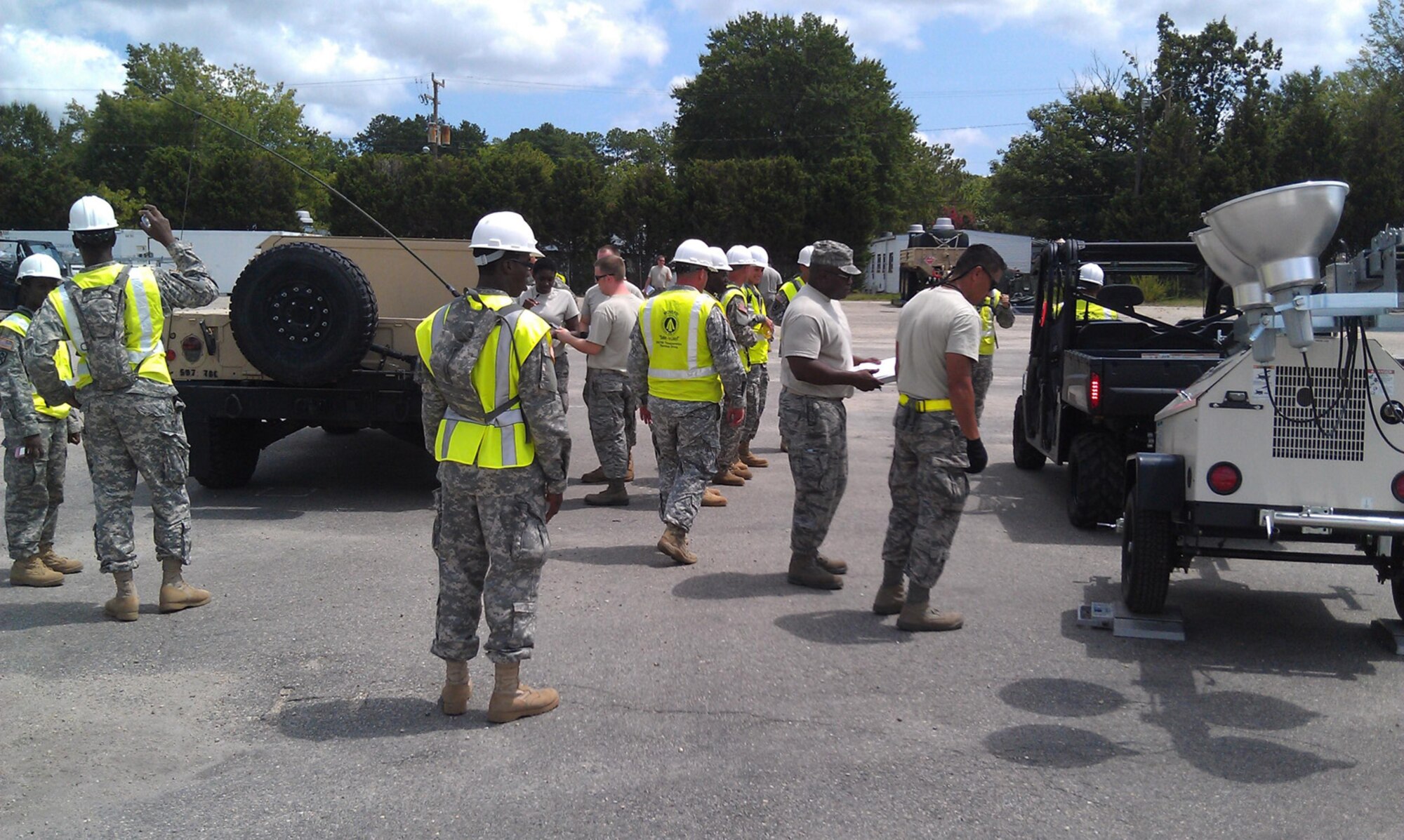 Soldiers from the 690th Rapid Port Opening Element, 597th Transportation Brigade, and Airmen from the 71st Aerial Port Squadron weigh and mark equipment in preparation for U.S. Transportation Command Joint Task Force-Port Opening's alert cycle at Fort Eustis Aug. 5. (U.S. Army photo by Spc. Anthony Burgess/RELEASED)