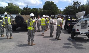Soldiers from the 690th Rapid Port Opening Element, 597th Transportation Brigade, and Airmen from the 71st Aerial Port Squadron weigh and mark equipment in preparation for U.S. Transportation Command Joint Task Force-Port Opening's alert cycle at Fort Eustis Aug. 5. (U.S. Army photo by Spc. Anthony Burgess/RELEASED)