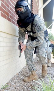 Spc. Trevor Stringer, 217th Military Police Detachment (Fort Lee), scaled a building with his partner before entering a school on post during an active-shooter exercise at Fort Eustis, Va., Aug. 19, 2011. Soldiers from six Training and Doctrine Command units from across the United States battled for bragging rights as this year’s “top cop.” (U.S. Air Force photo by Staff Sgt. Antoinette Gibson/RELEASED)