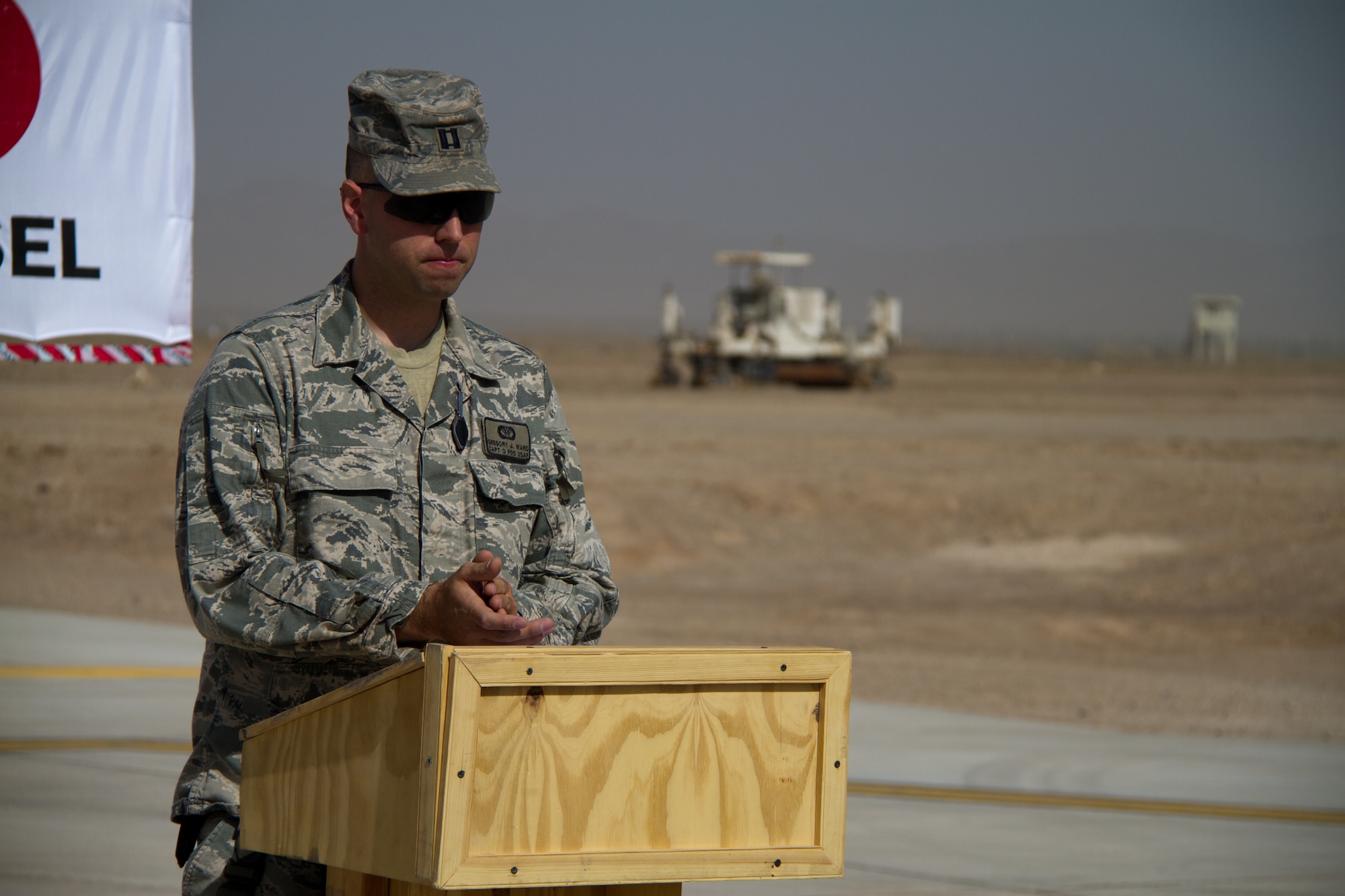 Capt. Gregory Ward, USACE Engineer at Shindand Air Base, addresses the crowd during the opening of the Shindand AB rotary wing apron August 15, 2011. The newly opened 112,000 square meter apron has the ability to park 14 CH-47 Chinooks, 18 UH-60 Blackhawks and 10 AH-64 Apache helicopters at one time. (U.S. Air Force Photo by 1st. Lt. Joel Cooke)