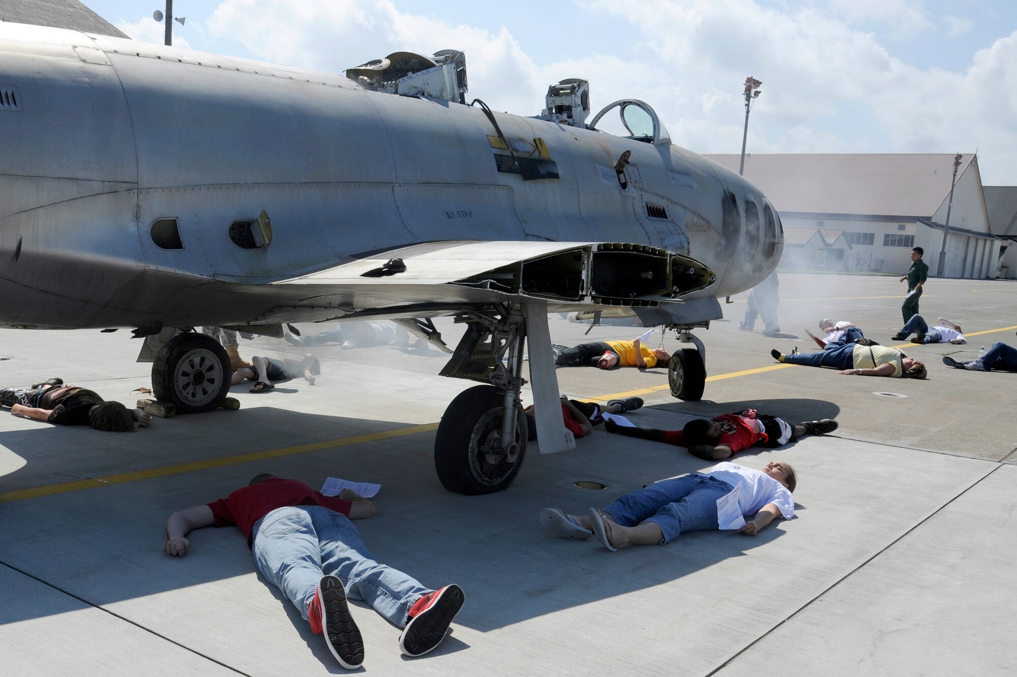 MISAWA AIR BASE, Japan -- Role players of a simulated Air Force F-16 Fighting Falcon wait for medical care on the flightline here during a major accident response exercise here Aug. 26. Approximately 100 volunteers participated as role players during the exercise. (U.S. Air Force photo/Tech. Sgt. Marie Brown)