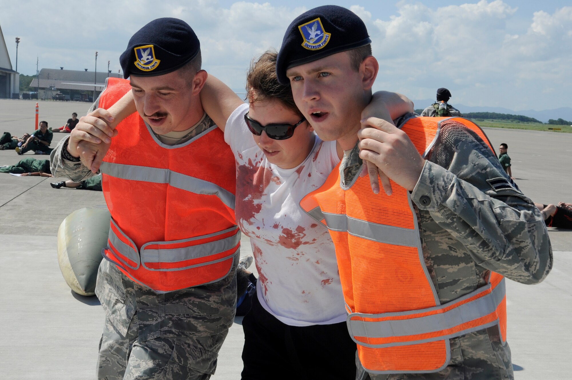 MISAWA AIR BASE, Japan -- Members of the 35th Security Forces Squadron transport a role player from the flightline during a major accident response exercise here Aug. 26. The MARE prepared emergency responders for the possibility of a real world accident during the upcoming Misawa Air Fest. (U.S. Air Force photo/Tech. Sgt. Marie Brown)