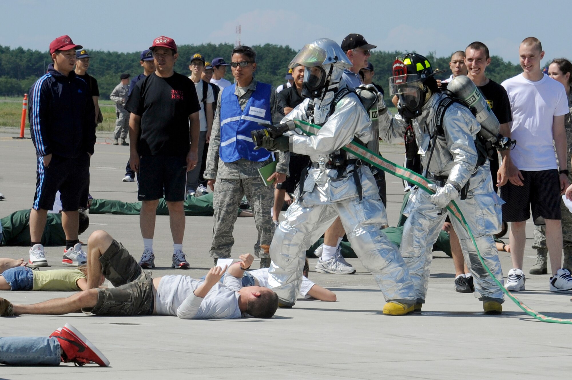 MISAWA AIR BASE, Japan -- Members of the 35th Civil Engineer Squadron simulate putting out an aircraft fire on the flightline here during a major accident response exercise here Aug. 26. The MARE provides training to improve real world readiness skills. (U.S. Air Force photo/Tech. Sgt. Marie Brown)