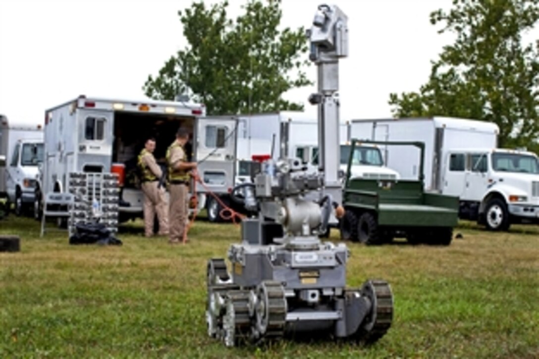 Marine Corps Sgts. Sean Hurcer and Jason Gastelon deploy an Andros remote robot during Vibrant Response 12.1 at the Muscatatuck Urban Training Center in Butlerville, Ind., Aug. 19, 2011. Hurcer and Gastelon are assigned to the Marine Corps Chemical Biological Incident Response Force. The Marines use the robot to dispose of explosive hazards encountered during relief efforts. The two-week exercise simulates the aftermath of a 10-kiloton nuclear detonation in Cincinnati.