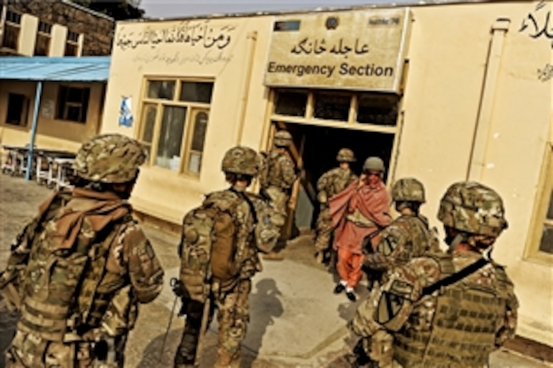 U.S. troops assigned to the Laghman Provincial Reconstruction Team enter the emergency care building at the Mehtar Lam Hospital in Afghanistan's Laghman province, Aug. 24, 2011. The troops are medical technicians and visited the hospital to determine if it had enough supplies and medical personnel to serve the area.