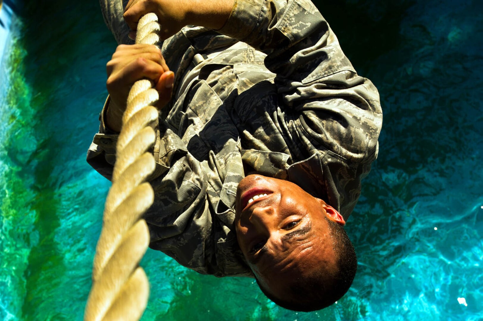 An Air Force basic military trainee attempts to finish an obstacle without falling off July 25 at Lackland Air Force Base. The obstacle course consists of 20 challenges designed to test strength, endurance and will power. (U.S. Air Force photo/Staff Sgt. Jonathan Snyder)