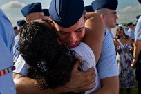 Airman Basic Corinthian Maldonado is greeted by his sister, Samantha Labron, for the first time since leaving for basic military training July 29 at Lackland Air Force Base. The 8 1/2-weeks-long program graduates more than 35,000 Airmen annually. (U.S. Air Force photo/Staff Sgt. Jonathan Snyder)