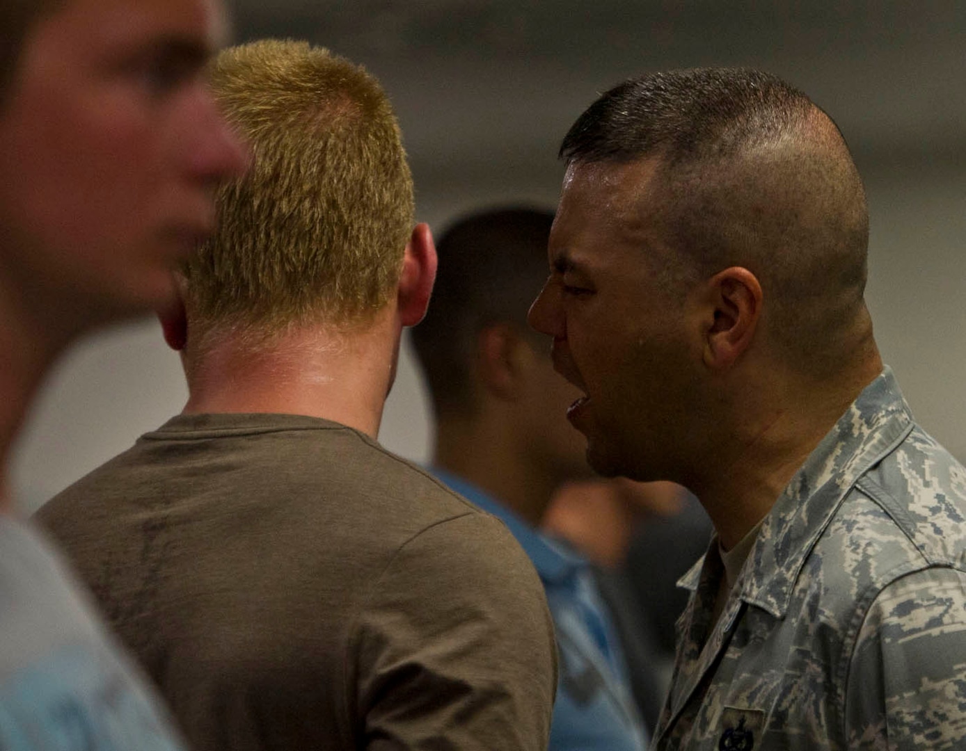 Tech. Sgt. Trevor Tiernan, 321st Training Squadron military training instructor, corrects a trainee Aug. 2 during the first few minutes of zero week at Lackland Air Force Base. (U.S. Air Force photo/Staff Sgt. Araceli Alarcon)
