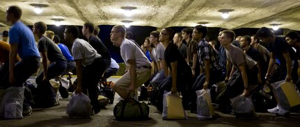 Newly arriving Air Force basic military trainees, assigned to the 321st Training Squadron, quickly set bags down Aug. 2 during zero week at Lackland Air Force Base.  More than 100 civilians arrived at Lackland for 8 1/2 weeks of training to become Airmen in the U.S. Air Force. (U.S. Air Force photo/Staff Sgt. Araceli Alarcon)