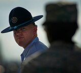 An Air Force Basic Military Training Instructor looks back at a trainee on the parade field during a BMT graduation ceremony at Lackland Air Force Base July 29. Following graduation, Airmen go on to technical training before their first Air Force assignment. More than 7 million Airmen have completed BMT since 1946. (U.S. Air Force photo/Staff Sgt. Vernon Young Jr.)