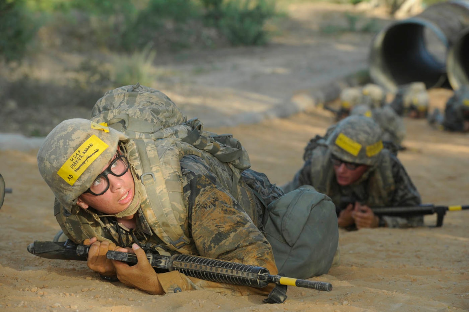 Air Force basic military trainee Aaron Parker crawls to the next point while participating in the Creating Leaders, Airmen and Warriors (CLAW) Course July 26 at Lackland Air Force Base. CLAW gives trainees the opportunity to overcome obstacles under physical and mental stress. (U.S. Air Force photo/Staff Sgt. Matt Davis)