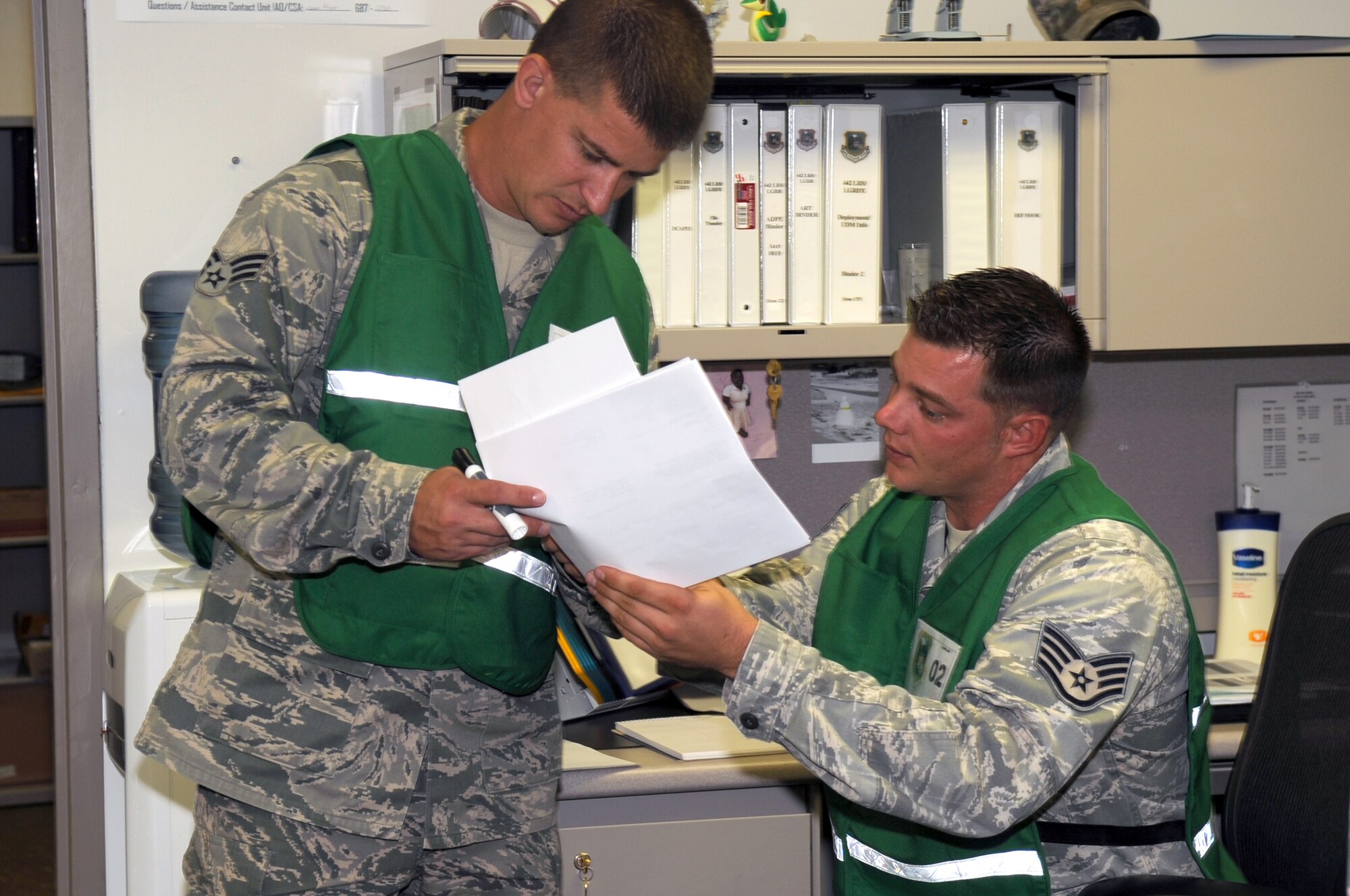 Senior Airman William Francis and Staff Sgt. Peter Koontz, both of the 442nd Mission Support Group, discuss a change to the flight schedule during a phase-one operational readiness  inspection; Logistics technicians are responsible for ensuring all aircraft take off on time and all Airmen and cargo set to "deploy" are scheduled and able to head to the area of responsibility. The 442nd MSG is part of the 442nd Fighter Wing, an A-10 Thunderbolt II Air Force Reserve unit at Whiteman Air Force Base, Mo. (U.S. Air Force photo/Staff Sgt. Danielle Wolf)