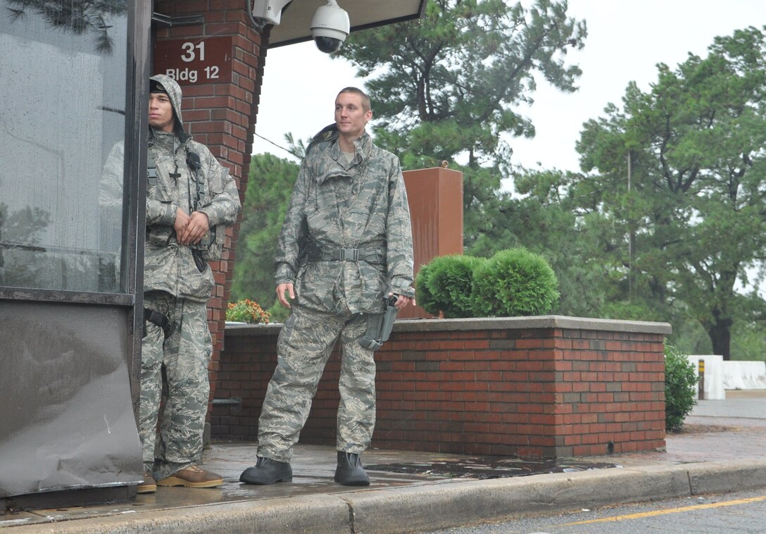 Airmen 1st Class Charles Stark and Ryan Bell, 633rd Security Forces Squadron, guard the LaSalle Avenue gate at Langley Air Force Base, Va., as Hurricane Irene approaches the area Aug. 27, 2011. Joint Base Langley-Eustis implemented evacuations, base closures and infrastructure protection measures to mitigate storm damage at Langley AFB and Fort Eustis. (U.S. Air Force photo by Senior Airman Jason J. Brown/RELEASED)