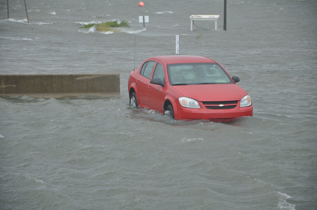 A vehicle parked at the Langley Marina becomes inundated with floodwaters as Hurricane Irene approaches Langley Air Force Base, Va., Aug. 27, 2011. Joint Base Langley-Eustis implemented evacuations, base closures and infrastructure protection measures to mitigate storm damage at Langley AFB and Fort Eustis. (U.S. Air Force photo by Senior Airman Jason J. Brown/RELEASED)