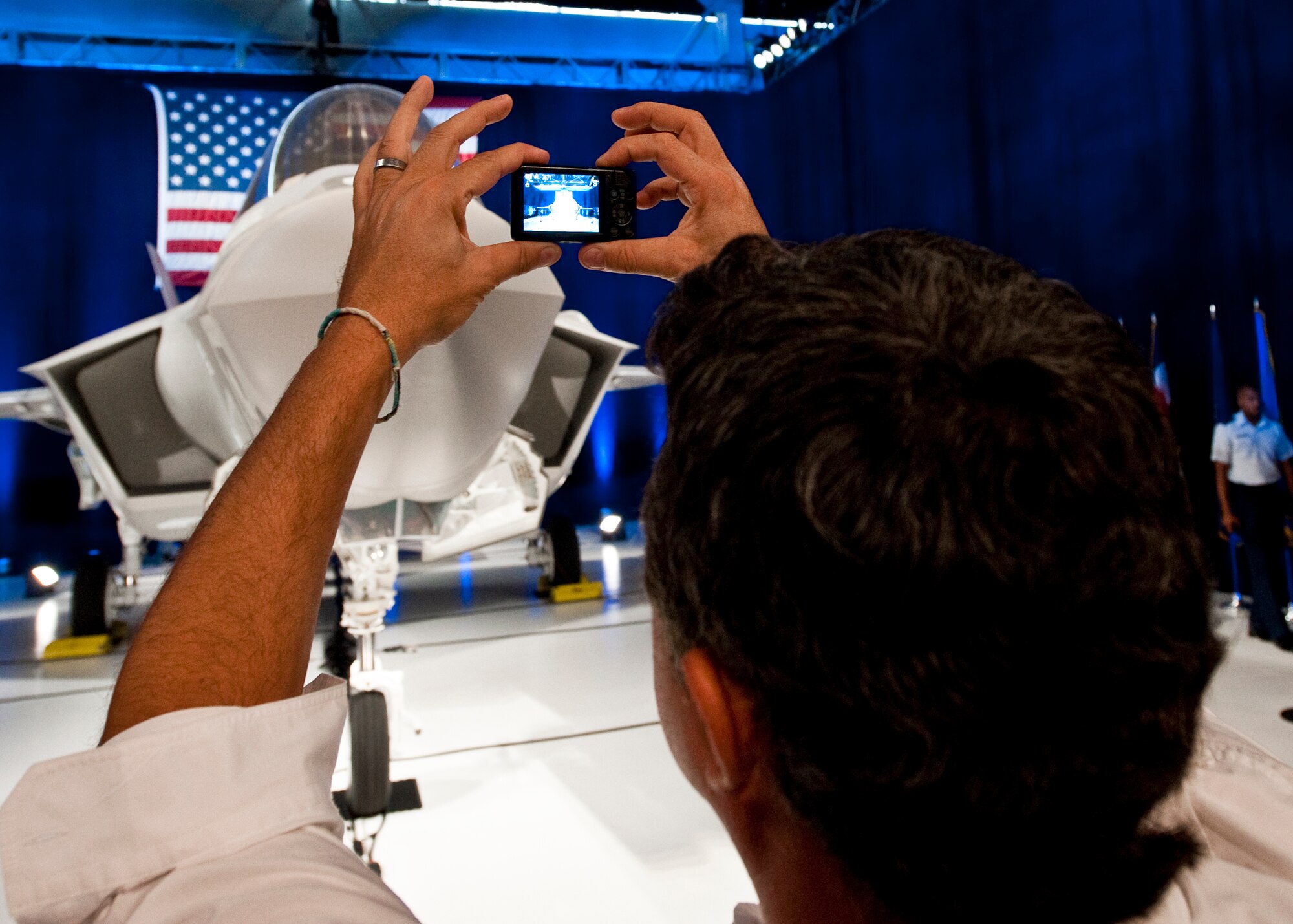 An attendee snaps a quick picture of the F-35 Lightning II joint strike fighter after its official rollout ceremony Aug. 26 at Eglin Air Force Base, Fla.  (U.S. Air Force photo/Samuel King Jr.)