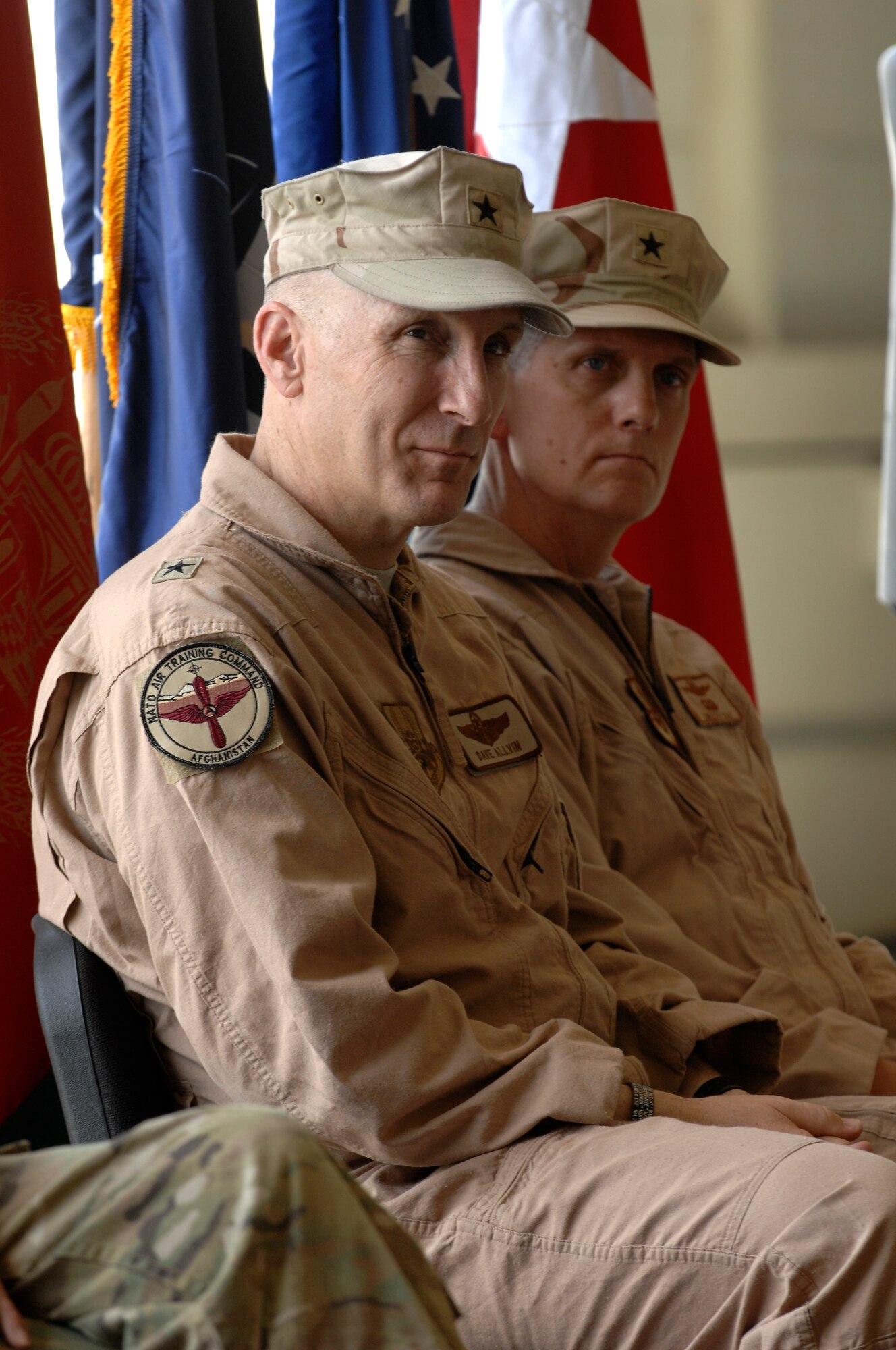 U.S. Air Force Brig. Gen. David Allvin, 438th Air Expeditionary Wing commander and Brig. Gen. Tim Ray listen to a speech during a change of command ceremony, Kabul International Airport, August 27, 2011. Ray took over command from Allvin as 438th AEW commander.    (U.S. Air Force photo by Staff Sgt. Matt Smith)