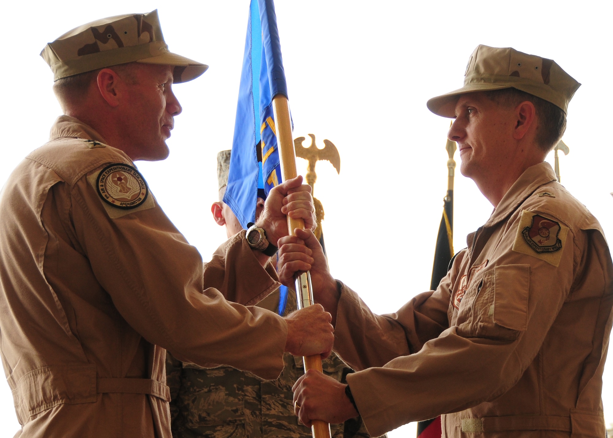 Brig. Gen. Tim Ray, 438th Air Expeditionary Wing Commander, takes the 438th AEW flag from Maj. Gen. Tod Wolters, Commander, 9th Air and Space Expeditionary Task Force – Afghanistan, during a change of command ceremony at Kabul International Airport, Kabul, Afghanistan August 27, 2011.  Ray took over command from Brig. Gen. David Allvin as 438th AEW commander.  (U.S. Air Force photo by Senior Airman Amber Williams)