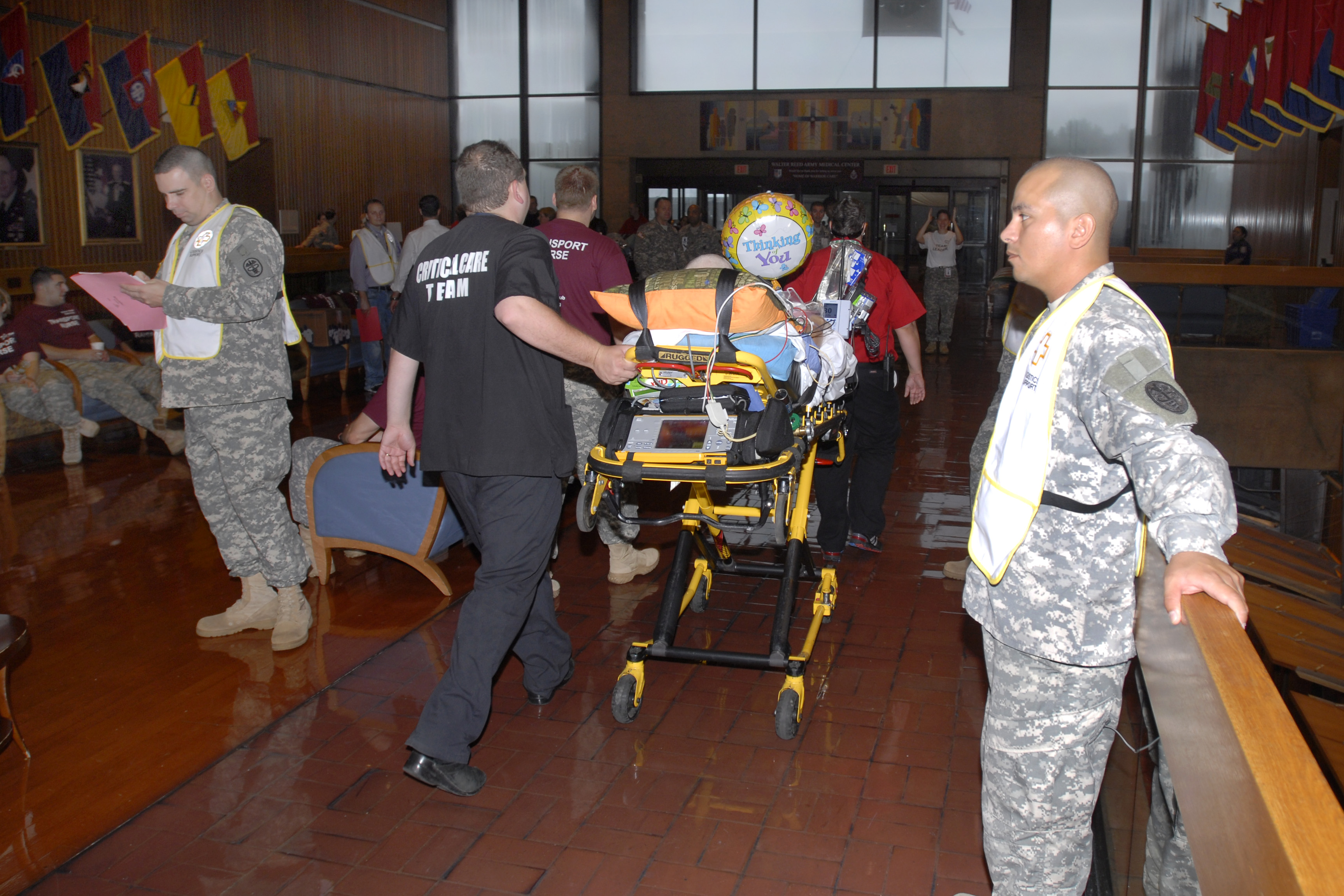 Soldiers and civilian workers move inpatients from Walter Reed Army Medical Center in Washington