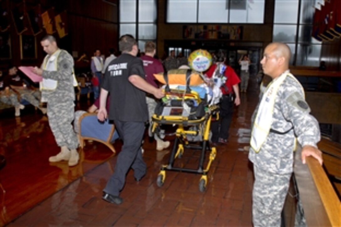 One of the last 18 patients leaves Walter Reed Army Medical Center  in Washington, D.C., Aug. 27, 2011, for the National Naval Medical Center in Bethesda, Md., marking the end of an era before the two flagship hospital merge.