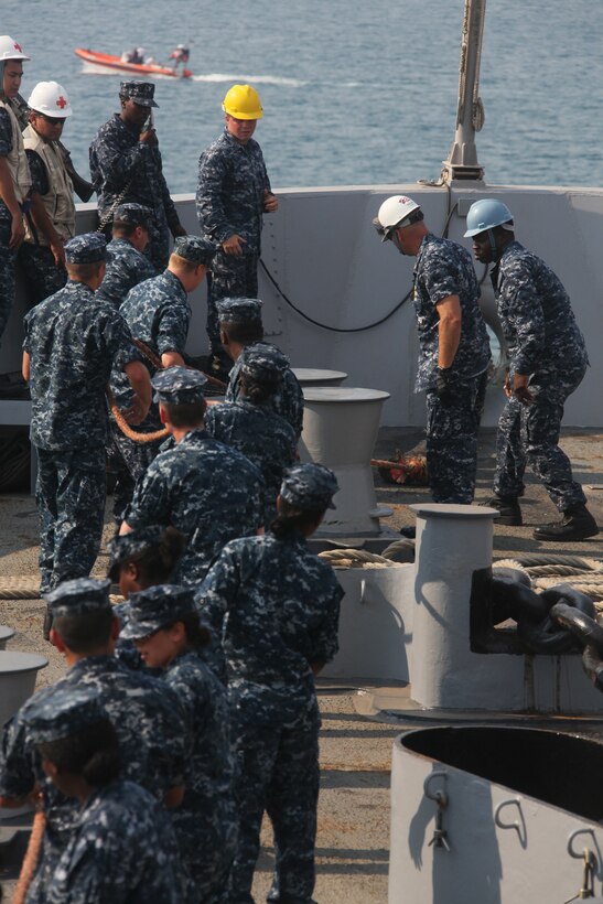 Sailors release a tug-boat line from the amphibious transport dock USS Mesa Verde (LPD 19), Aug. 27, 2011, after porting into Naval Air Station Sigonella, Italy. Marines and sailors of the 22nd MEU are currently deployed with Amphibious Squadron 6 aboard the USS Bataan Amphibious Ready Group and will continue to train and improve the MEU’s ability to operate as a cohesive and effective Marine Air Ground Task Force.  The 22nd MEU is a multi-mission, capable force, comprised of an Aviation Combat Element, Marine Medium Tilt Rotor Squadron 263 (Reinforced); a Logistics Combat Element, Combat Logistics Battalion 22; a Ground Combat Element, Battalion Landing Team, 2nd Battalion, 2nd Marine Regiment; and its Command Element.