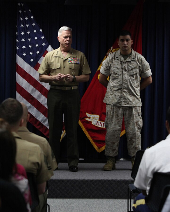 Gen. James F. Amos, 35th Commandant of the U.S. Marine Corps, talks with Marines before promoting Jerome Atger to rank of staff sergeant at U.S. Embassy Lima. Amos stopped to visit the Marines while attending the Marine Leaders of the Americas Conference (MLAC) 2011. The MLAC is an international conference designed to increase engagement among the partner nation's Marine Corps and Naval Infantries. (U.S. Marine Corps photo by Lance Cpl. Angel Canosaldivias/Released)::r::::n::::r::::n::