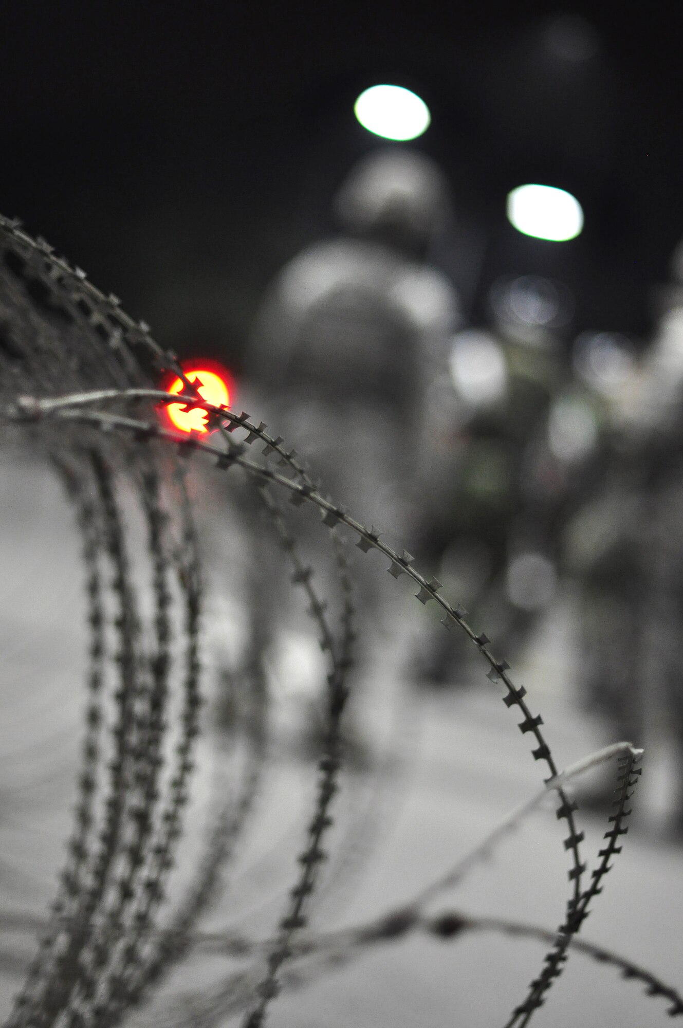As threat levels raise members of both the 51st Security Forces Squadron and base augmentees place concertina wire around the base Aug. 29, 2011 during exercise Beverly-Midnight 11-04. Exercises such as this test Osan's ability to survive and operate during a war-time constraint. (U.S. Air Force photo/Tech. Sgt. Chad Thompson)