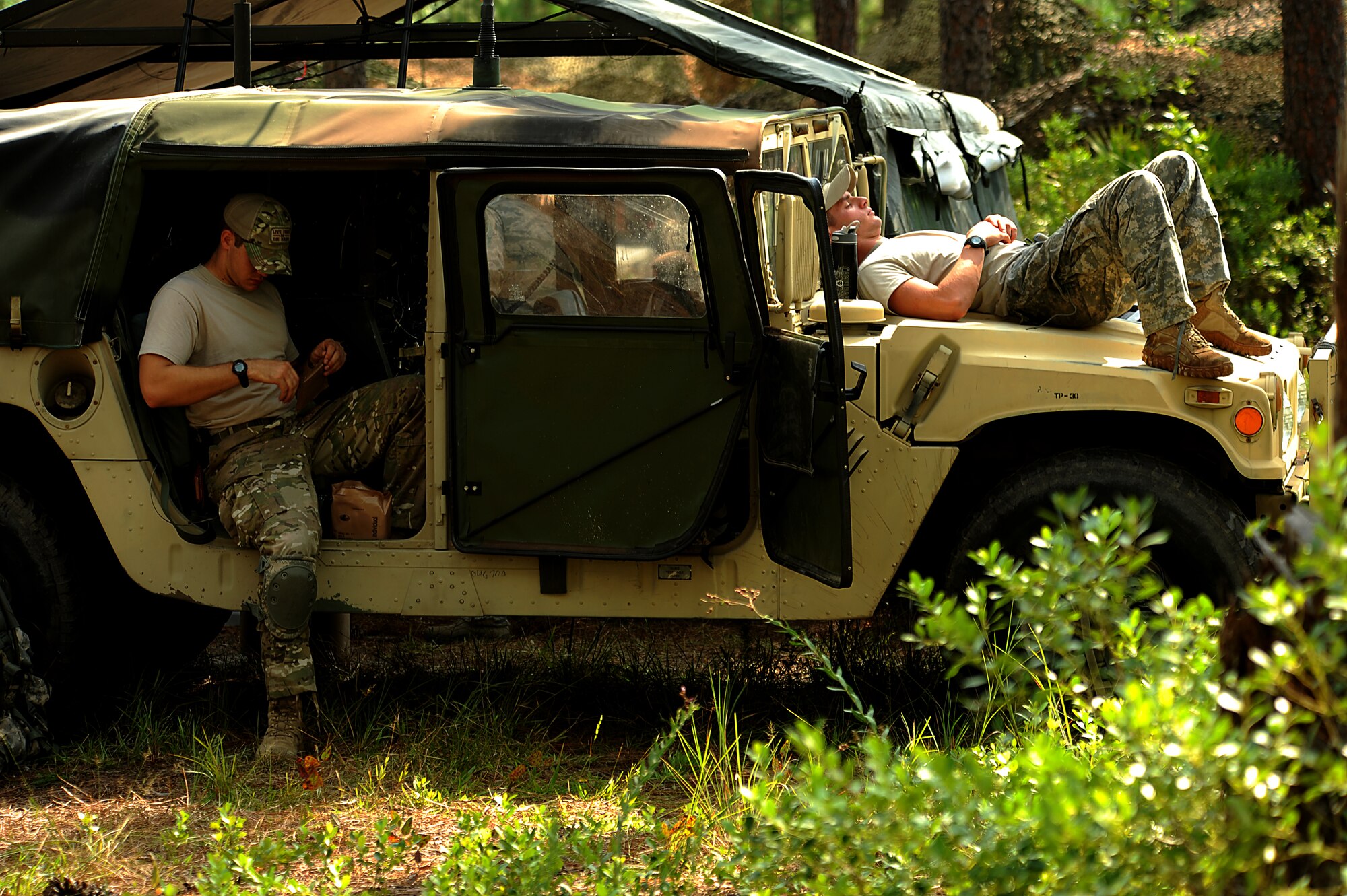 Tactical Air Control Party (TACP)  Airmen attached to the 165th Air Support Operations Squadron, Brunswick, GA get some down time at thier Forward Operating Base to rest and eat an MRE before their next challenge is given to them on August 16, 2011 at Townsend Range during a three day field exercise in Brunswick, GA. The exercise is the final phase of their 45 day training class "Project 175" where they will bring everything they have learned throughout the course and apply it to this scenario earning them their five level. During exercises, contingencies, or actual war, the Air Support Operations mission is to provide meteorological support and deploy with, advise, and assist the ground force commander in planning, requesting, coordinating and controlling close air support, tactical air reconnaissance, and tactical airlift.