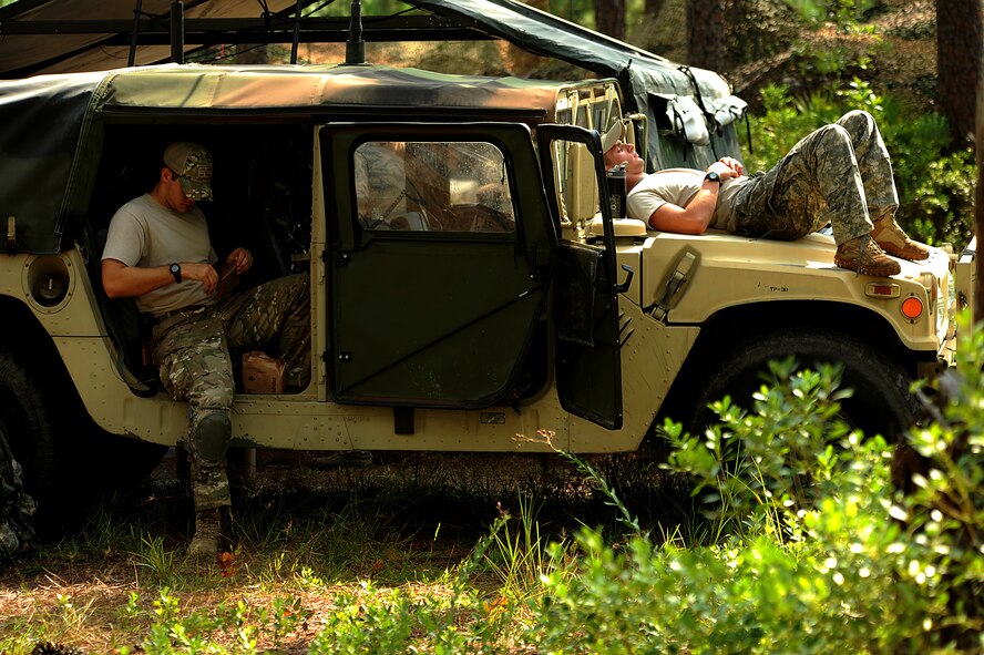 Tactical air control party specialists rest and eat Meals, Ready to Eat before their next challenge during a field training exercise Aug. 16, 2011, at Townsend Range in Brunswick, Ga. The exercise is the final phase of their 45-day training program called "Project 275", during which the Airmen will get certified on five-level tasks. (U.S. Air Force photo/Master Sgt. Jeremy Lock)