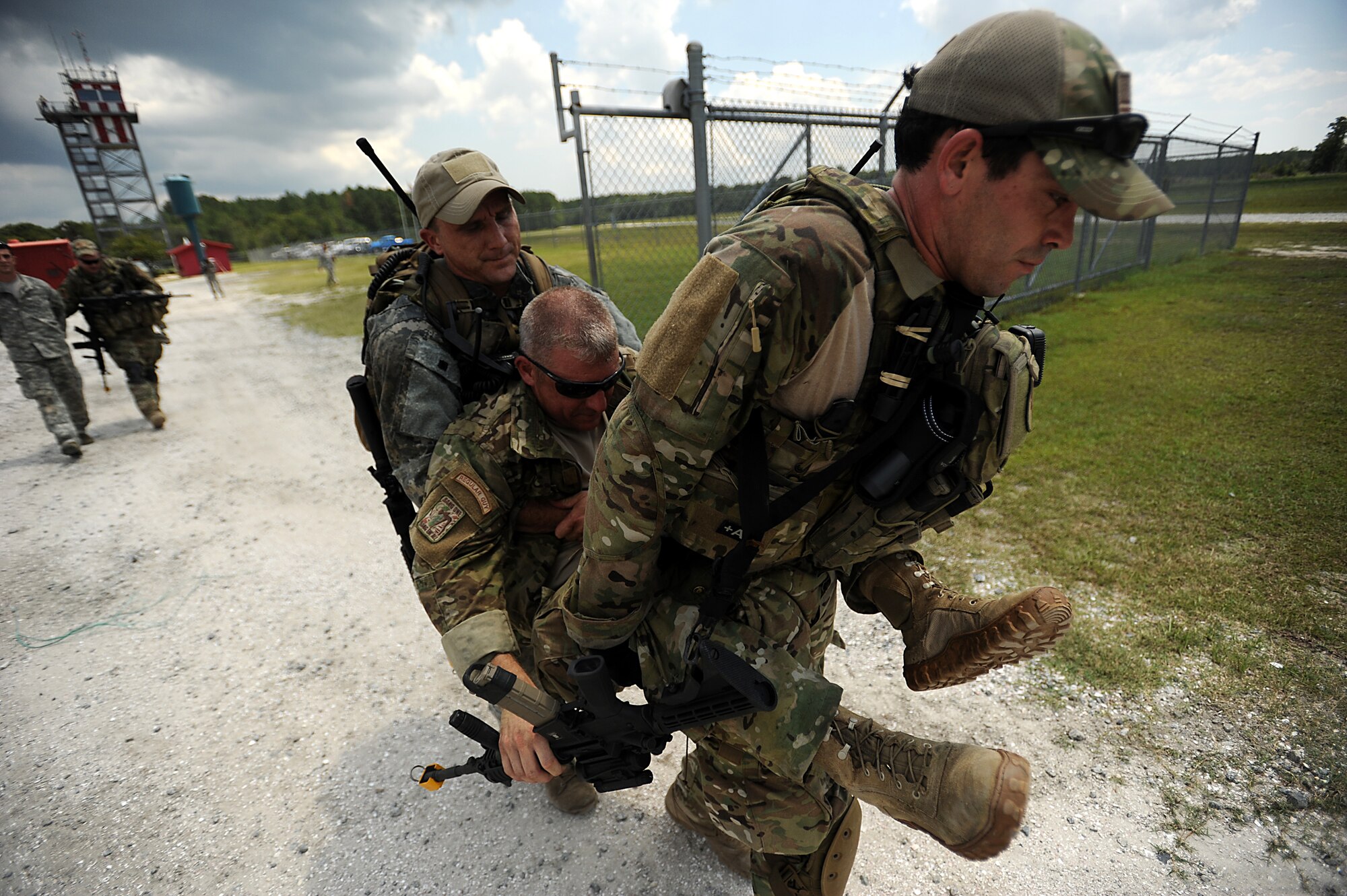 Tactical Air Control Party (TACP)  SSgt. Nathan Angel and TSgt. Billie Knesek carry a simulated injured SrA Dusty Smith to an extraction zone on August 16, 2011 at Townsend Range during a three day field exercise in Brunswick, GA. The exercise, is the final phase of their 45 day training class "Project 175", hosted by the 165th Air Support Operations Squadron, where they will bring everything they have learned throughout the course and apply it to this scenario earning them their five level. During exercises, contingencies, or actual war, the Air Support Operations mission is to provide meteorological support and deploy with, advise, and assist the ground force commander in planning, requesting, coordinating and controlling close air support, tactical air reconnaissance, and tactical airlift.