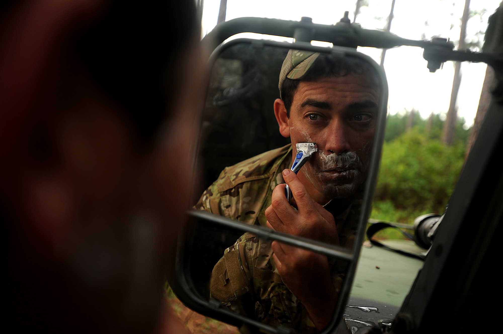 Tactical air control party specialist Staff Sgt. Nathan Angel gets in a quick shave before heading out on patrol during a field training exercise Aug. 16, 2011, at Townsend Range in Brunswick, Ga. The exercise is the final phase of a 45-day training program called "Project 275," during which the Airmen will get certified on five-level tasks. Angel is assigned to the 147th Air Support Operations Squadron with the Texas Air National Guard in Houston. (U.S. Air Force photo/Master Sgt. Jeremy Lock)
