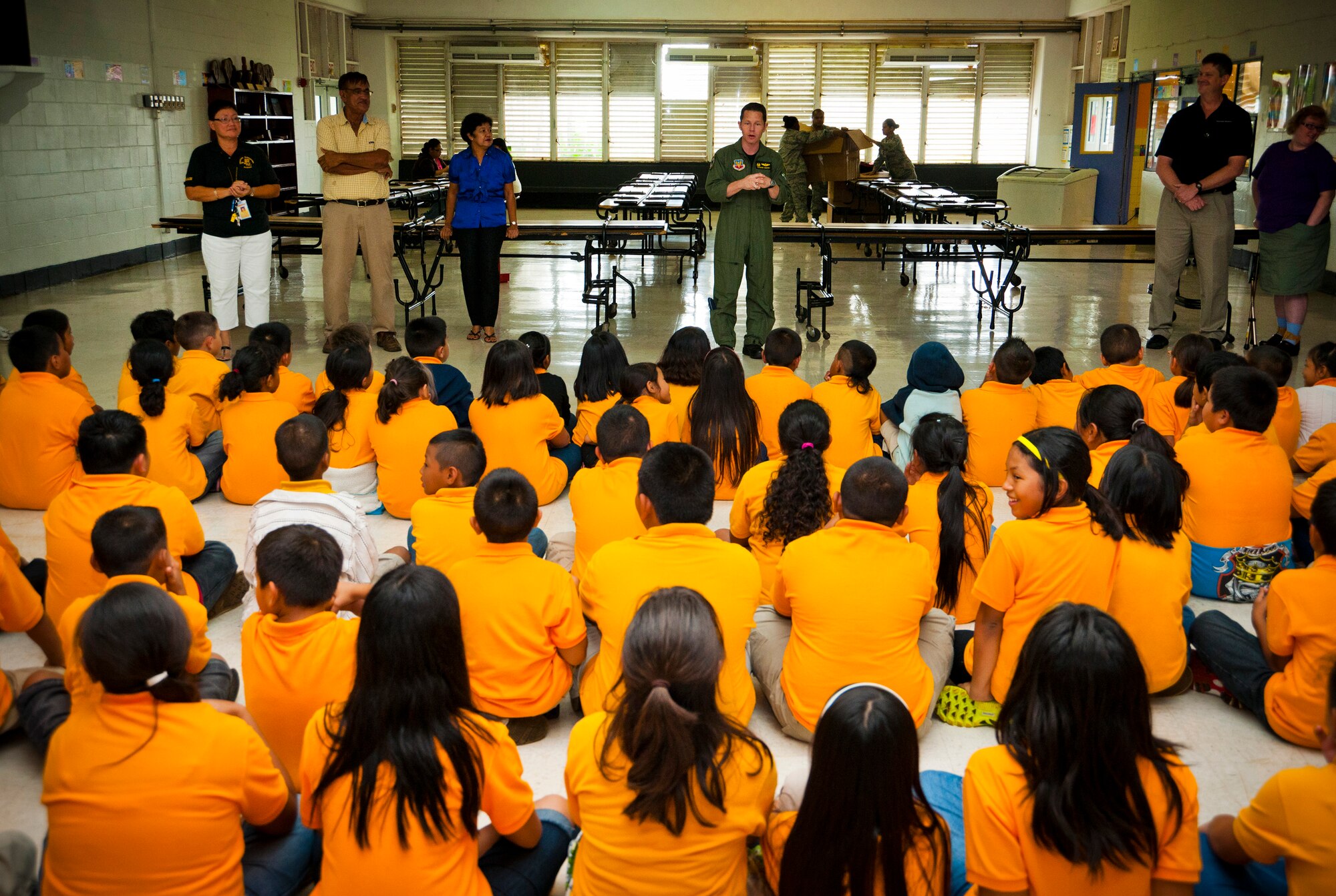 TALOFOFO, Guam-- U.S. Air Force Lt. Col. Raymond Simmons, 9th Operations Group Detachment 3 commander, speaks with local school children at Talofofo Elementary School Aug. 25. Personnel assigned to the 9th Operations Group Det. 3, which included civilian contracted workers along with active duty Air Force personnel, worked together to provide school supplies to children in their adopted village. (U.S. Air Force photo by Senior Airman Benjamin Wiseman/Released)