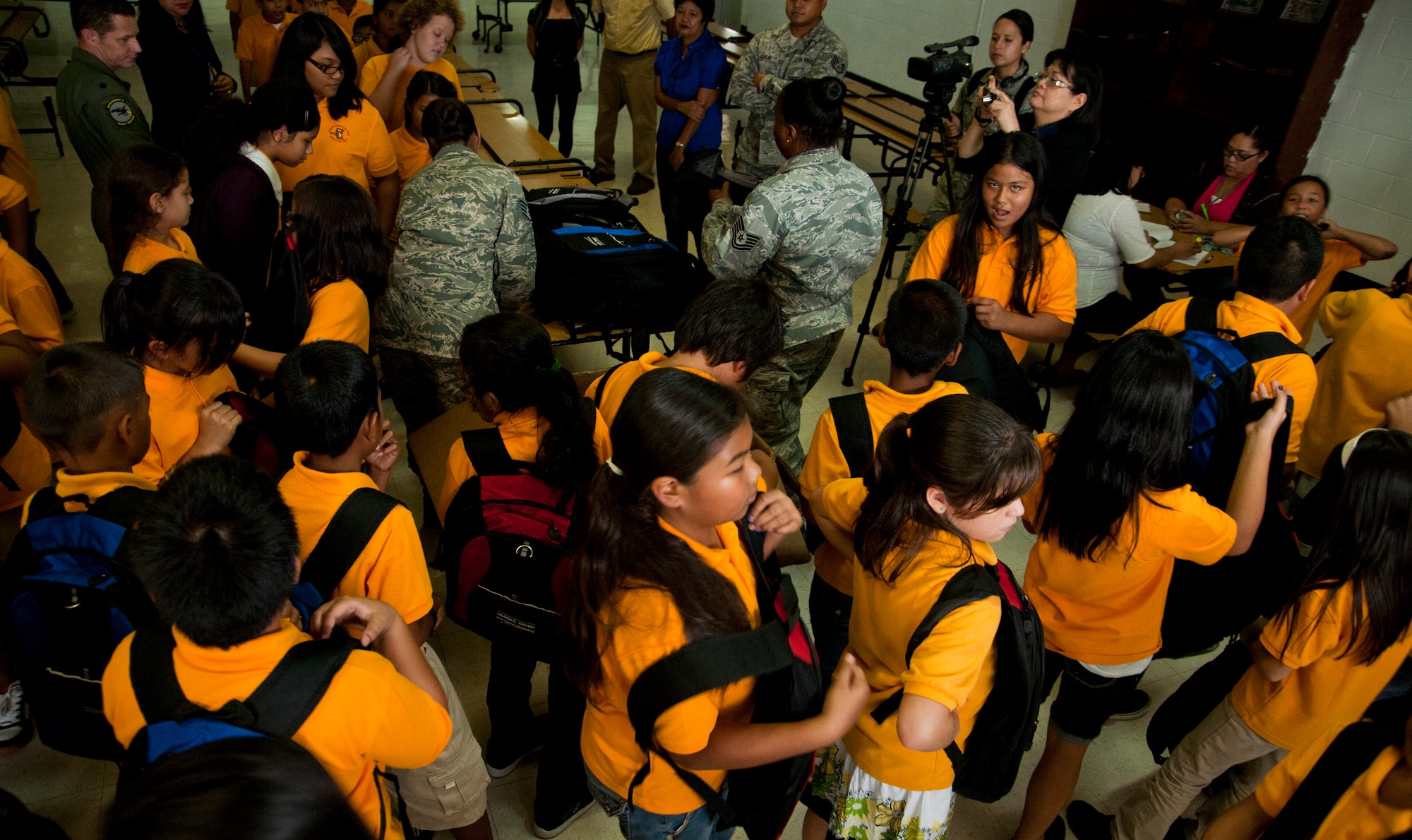 TALOFOFO, Guam— School children from Talofofo Elementary School line up for class after receiving backpacks from Airmen assigned to the 9th Operations Group Detachment 3 Aug. 25.  Contracted workers and Airmen from Det. 3 worked together to ensure that local children have the necessary supplies throughout the school year. (U.S. Air Force photo by Senior Airman Benjamin Wiseman/Released)