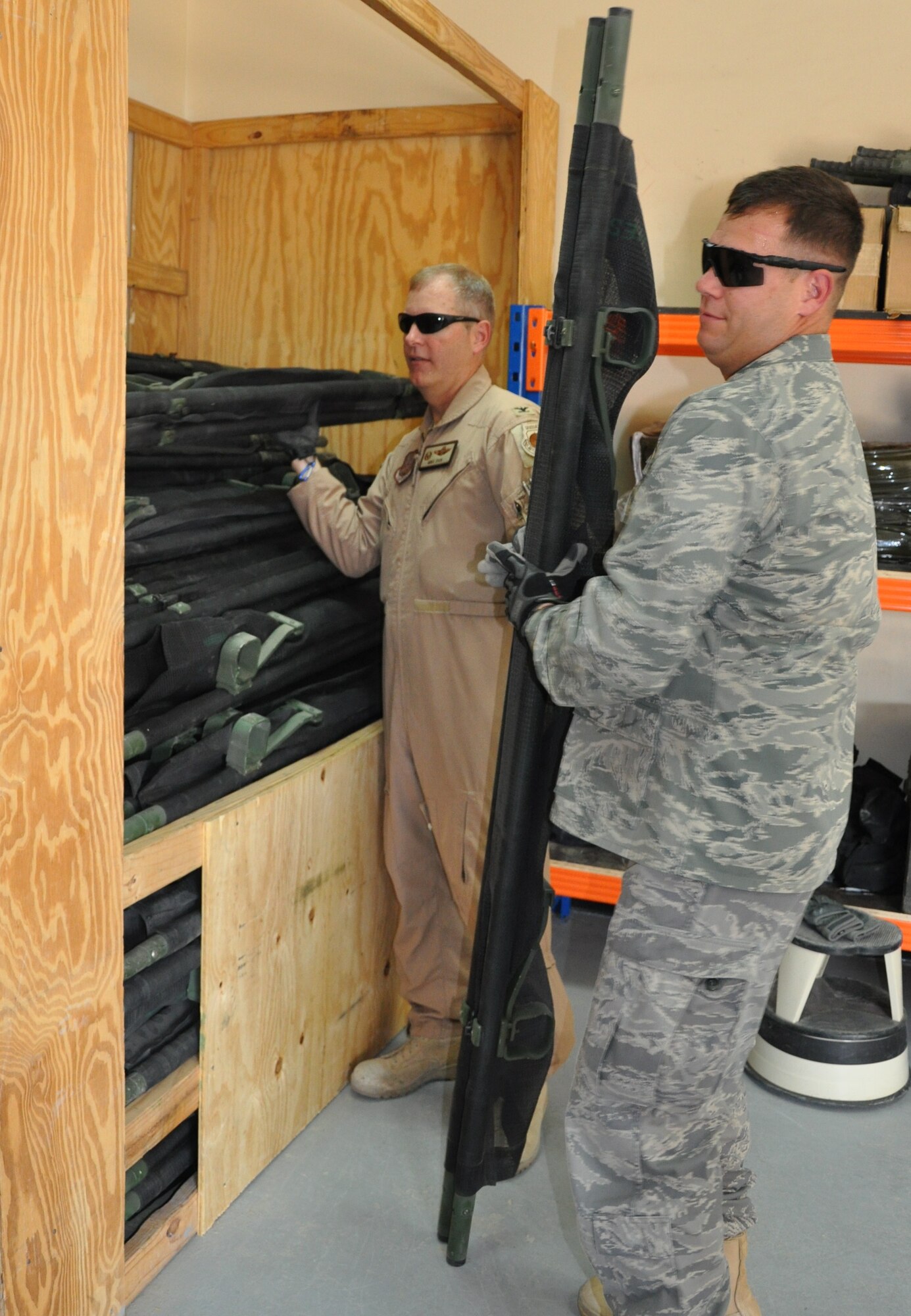 Col. Michael Zick, 386th Air Expeditionary Wing commander, and Col. William Summers, 386th AEW vice commander, gather items for the first Patient Movement Item hub order Aug. 26 at an undisclosed location in Southwest Asia. (U.S. Air Force photo by Senior Airman Rachelle Elsea)