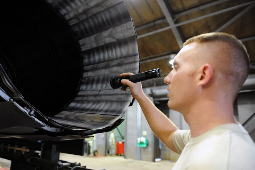 KUNSAN AIR BASE, Republic of Korea -- Senior Airman Kurt Ranes, 8th Maintenance Squadron aerospace propulsion journeyman, performs maintenance on an F-16 Fighting Falcon engine here Aug. 25. The propulsion flight is a centralized repair facility responsible for facilitating maintenance on the jet engine around the clock. (U.S. Air Force photo/Senior Airman Brittany Y. Bateman)