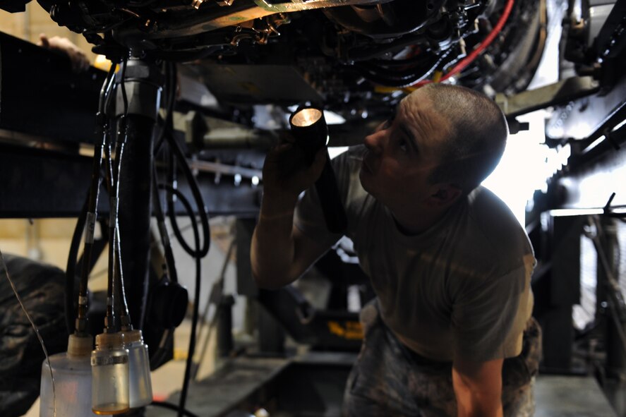 KUNSAN AIR BASE, Republic of Korea -- Senior Airman Eric MacPherson, 8th Maintenance Squadron aerospace propulsion journeyman, takes an oil sample from an F-16 Fighting Falcon engine here Aug 24. The propulsion flight is a centralized repair facility responsible for facilitating maintenance on the jet engine around the clock. (U.S. Air Force photo/Senior Airman Brittany Y. Bateman)