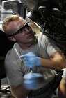 KUNSAN AIR BASE, Republic of Korea -- Senior Airman Kurt Ranes, 8th Maintenance aerospace propulsion journeyman, performs maintenance on an F-16 Fighting Falcon engine here Aug. 24. The propulsion flight is a centralized repair facility responsible for facilitating maintenance on the jet engine around the clock. (U.S. Air Force photo/Senior Airman Brittany Y. Bateman)