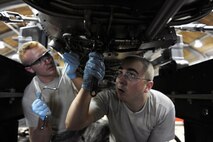 KUNSAN AIR BASE, Republic of Korea -- Senior Airmen Kurt Ranes and Eric MacPherson, 8th Maintenance Squadron aerospace propulsion journeymen, perform maintenance on an F-16 Fighting Falcon engine here Aug. 24. The 8th Maintenance Group provides munitions, aircraft maintenance and maintenance operations support. (U.S. Air Force photo/Senior Airman Brittany Y. Bateman)