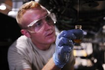 KUNSAN AIR BASE, Republic of Korea -- Senior Airman Kurt Ranes, 8th Maintenance Squadron aerospace propulsion journeyman, takes an oil sample from an F-16 Fighting Falcon engine here Aug 24. The propulsion flight is a centralized repair facility responsible for facilitating maintenance on the jet engine around the clock. (U.S. Air Force photo/Senior Airman Brittany Y. Bateman)